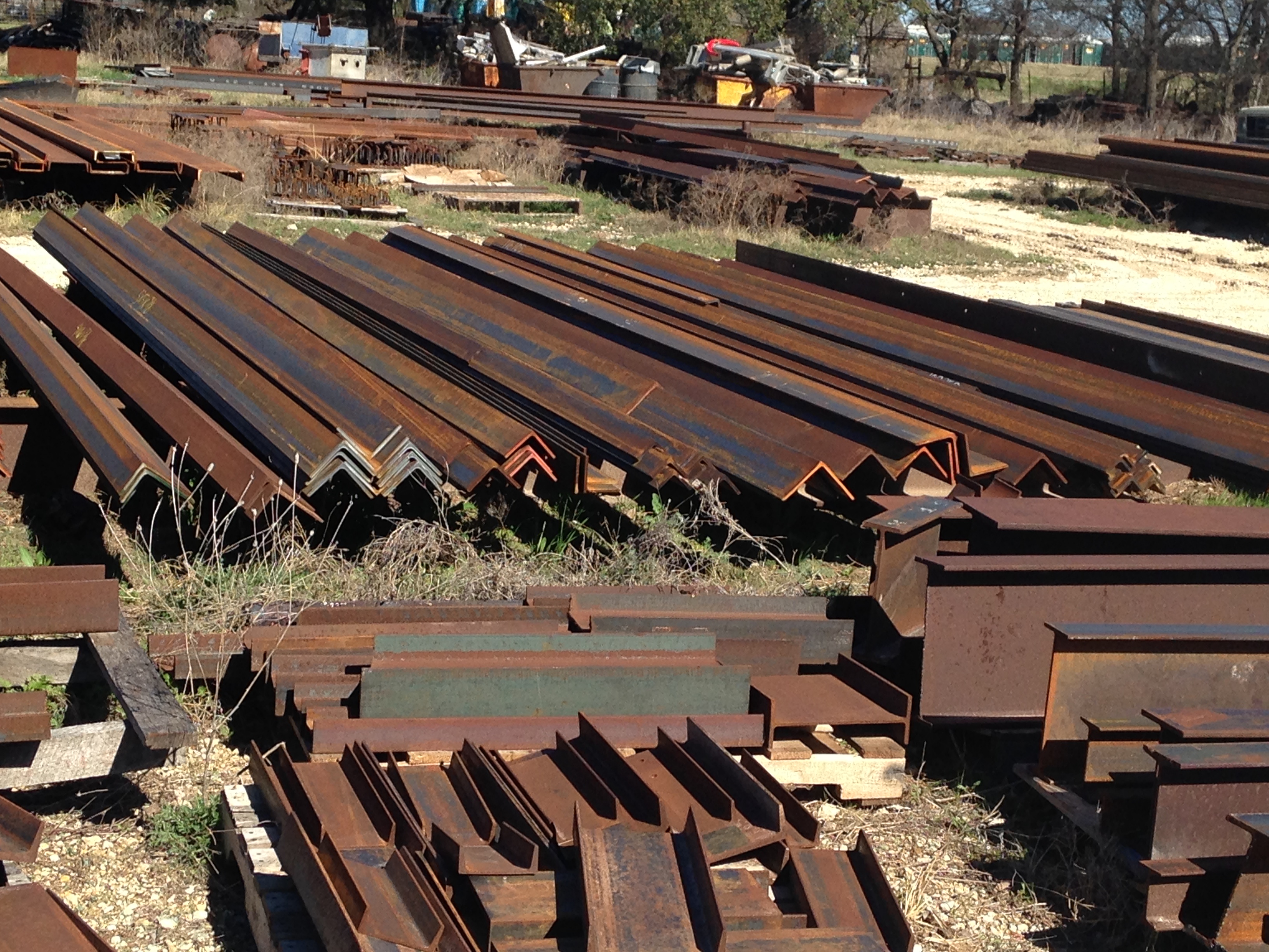 Structural angle iron and channel stock stacked in the Riggs metal yard, Stephenville, TX