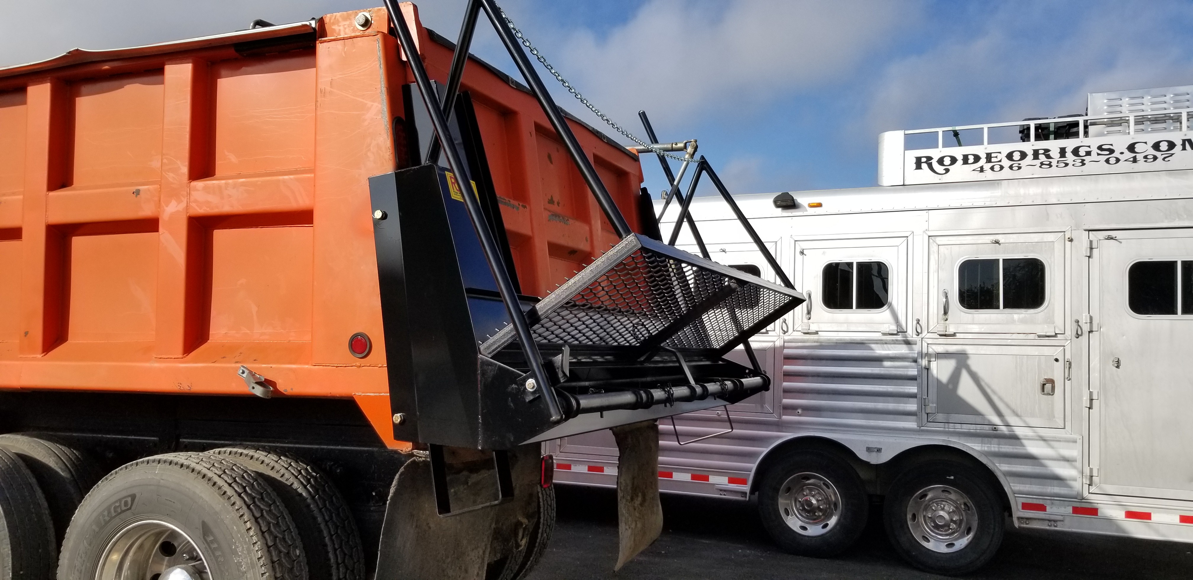 Custom chip spreader with fabricated catwalk mounted on orange dump truck, built by Riggs Machine & Welding in Stephenville, TX
