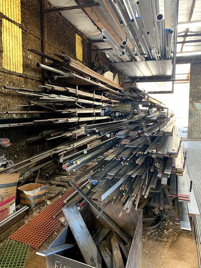 I-beams and H-beams stacked on a cantilever rack at the Riggs Machine & Welding yard in Stephenville, TX